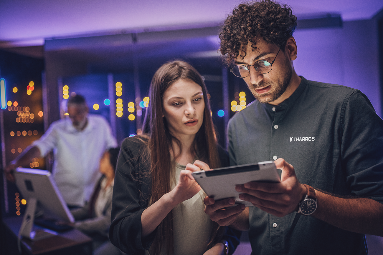 man and woman look at tablet